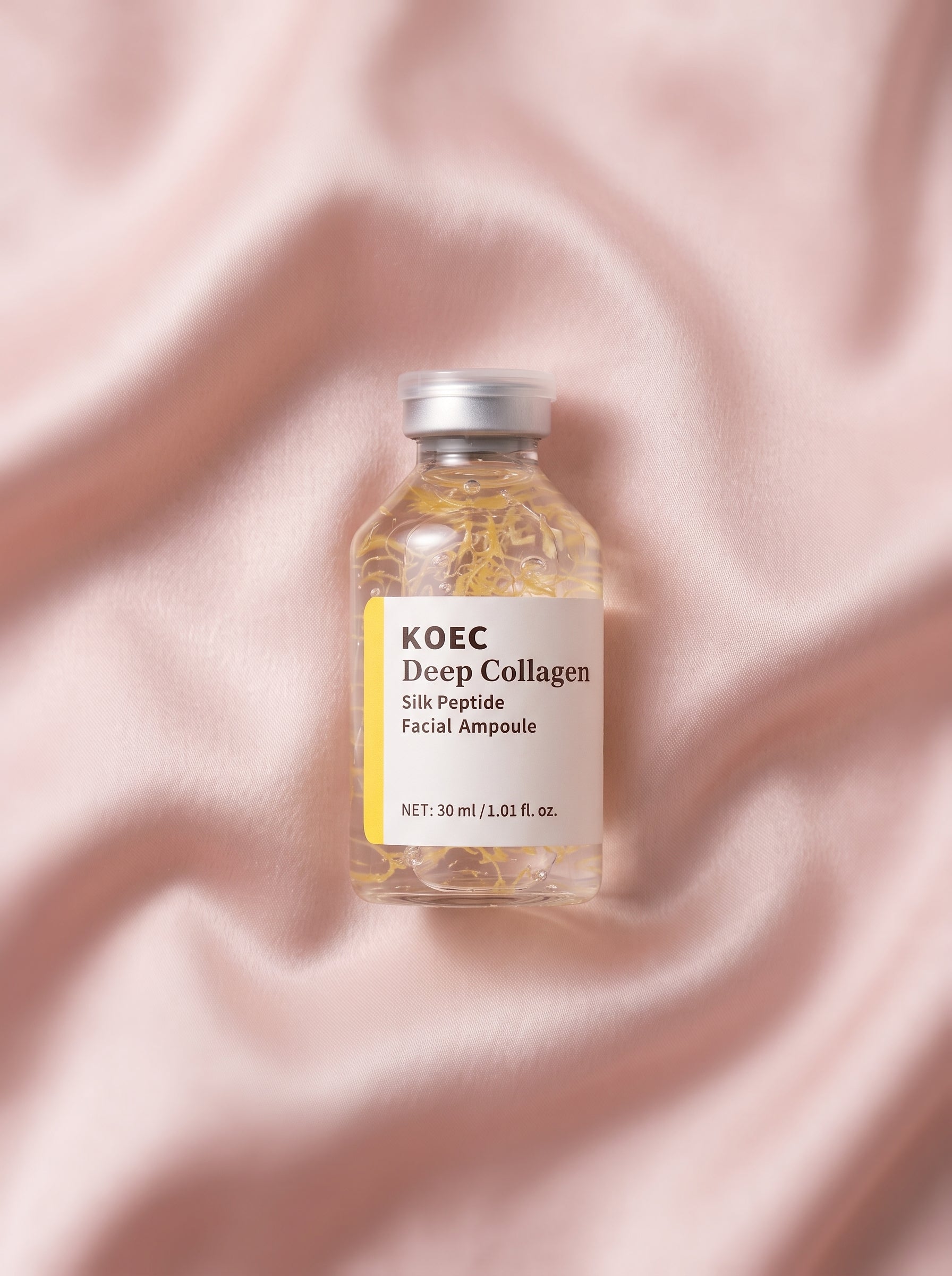 Ampolla KOEC Deep Collagen sobre seda rosa — péptidos de seda